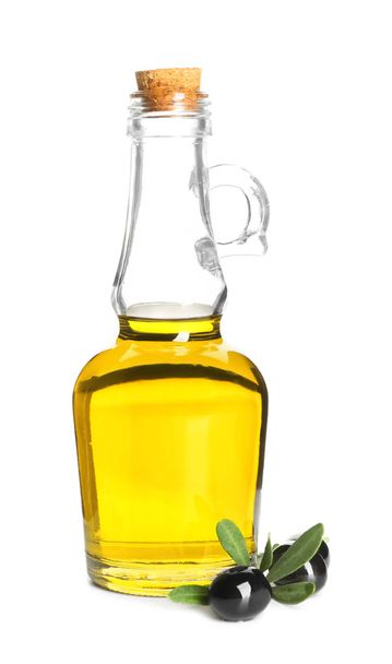 Fresh olive oil in jug and black olives on white background - Фото, изображение