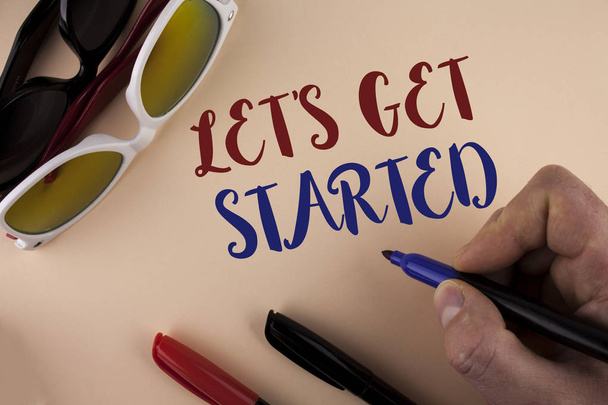 Text sign showing Lets Get Started. Conceptual photo beginning time motivational quote Inspiration encourage written by Man on plain background holding Marker Sun Glasses and Markers next to it - Photo, Image