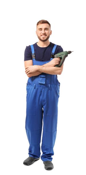 Male car mechanic with drill on white background - Foto, afbeelding