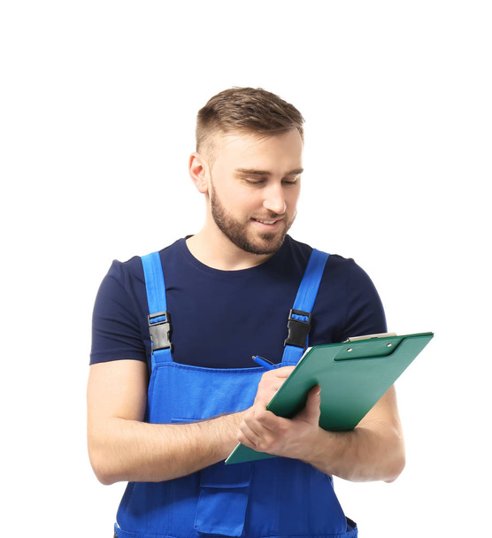 Male car mechanic with clipboard on white background - Photo, Image