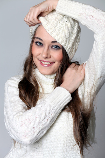 portrait of a beautiful happy woman in a knitted jacket - Fotó, kép
