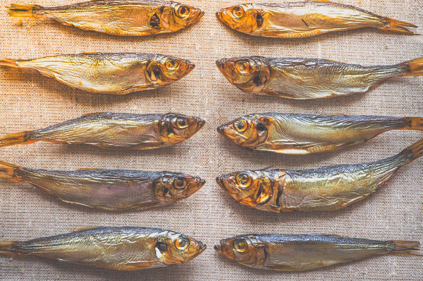 Smoked herring fish. Delicious smoked fish on the burlap. - Photo, Image