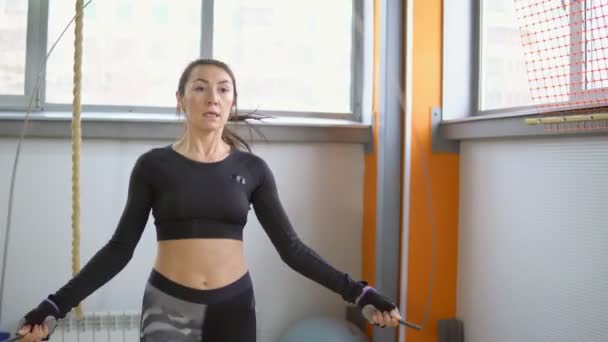 Cardio training with the gym. Young woman jumping rope - Footage, Video