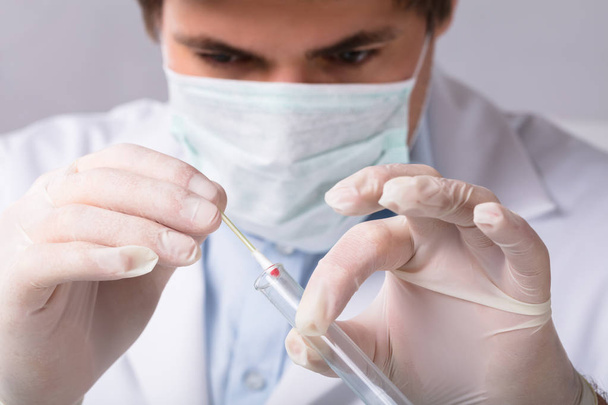 Close-up Of A Forensic Expert Taking Blood Sample With Cotton Swab - Φωτογραφία, εικόνα