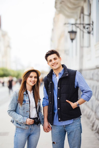 Couple of young tourists on the street with their backpack. Travel concept. - 写真・画像