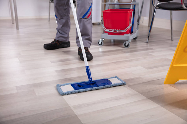 Cleaner Cleaning Hardwood Floor With Mop At Workplace - Foto, Imagen