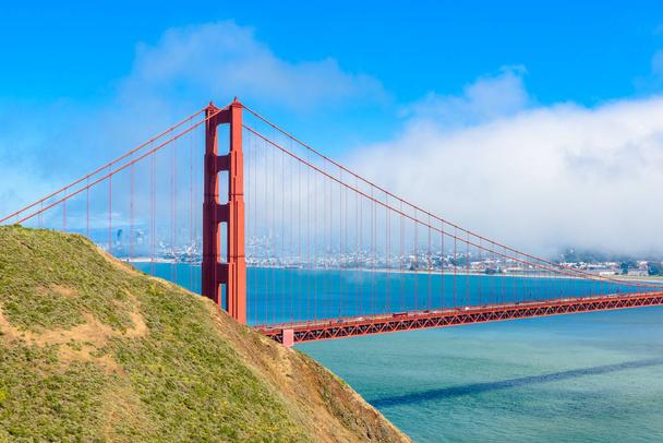 Golden Gate Bridge z skyline z San Francisco w tle w piękny słoneczny dzień z blue sky i chmury w lecie - panoramiczny widok z baterii Spencer - San Francisco Bay Area, Golden Gate National Recreation Area, California, Stany Zjednoczone Ameryki - Zdjęcie, obraz