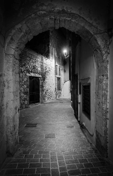 View of a stonewall street through an arch at night, Chania, Crete, Greece - Photo, Image