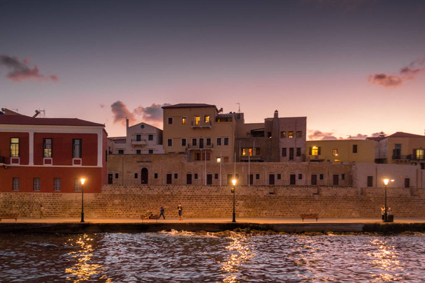 View of building exterior and pedestrian walkway from a distance, Chania, Crete, Greece - Photo, Image
