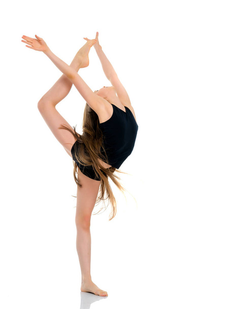 The gymnast balances on one leg. - Foto, Imagen