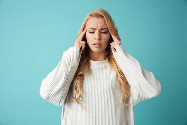 Portrait of a young blonde girl having a headache - Photo, image