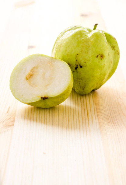 The tropical fruit high vitamin c, fresh guavas on wood background - Φωτογραφία, εικόνα