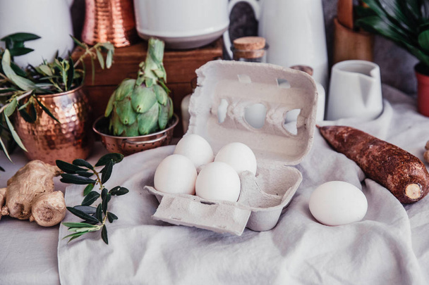 Still life in Rustic style . Fresh eggs on linen table. Organic eco farm products  - Foto, afbeelding