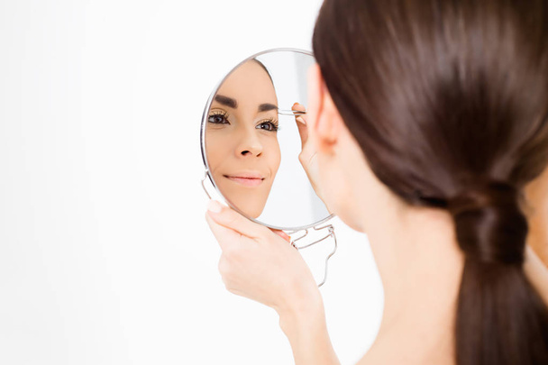Beautiful young woman with clean skin and   mirror posing on  background. Beauty and spa. Face and body care. Women's health. Cosmetology. - Foto, imagen
