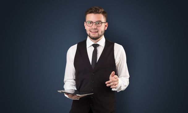 Businessman holding tablet with dark background - Фото, зображення