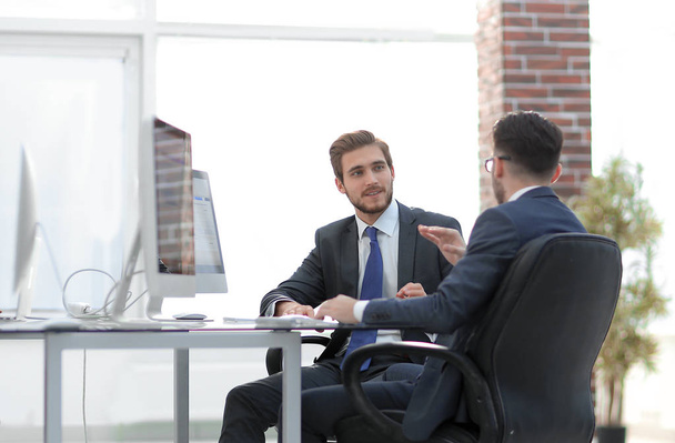 Image of two young businessmen interacting at meeting in office - Photo, Image