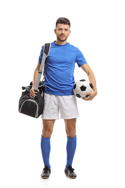 Full length portrait of a soccer player with a sports bag and a football isolated on white background - Photo, Image