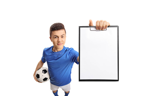 Teenage soccer player showing a clipboard isolated on white background - Фото, зображення