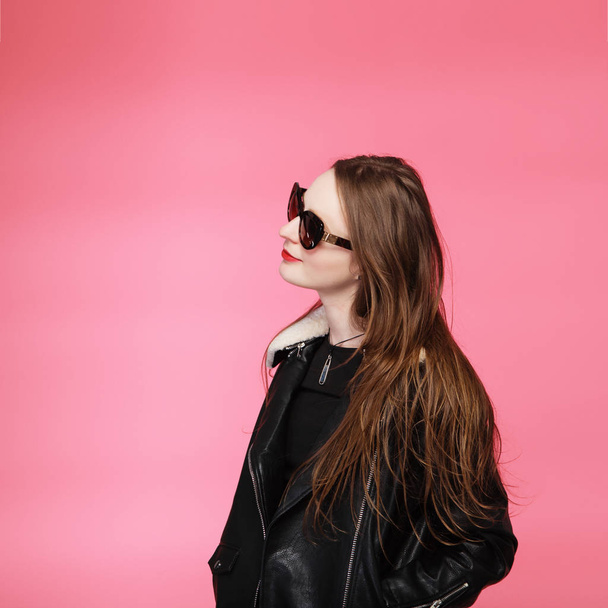 fashion model wearing black in sunglasses, beautiful young woman - Fotó, kép
