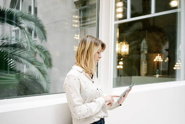 portrait of young beautiful blonde businesswoman with digital tablet in modern office interior - Fotografie, Obrázek