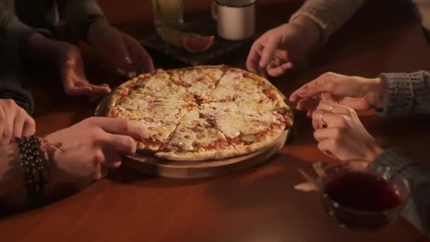 close up shot of peoples hands, men and women are dragged along piece of pizza - Footage, Video