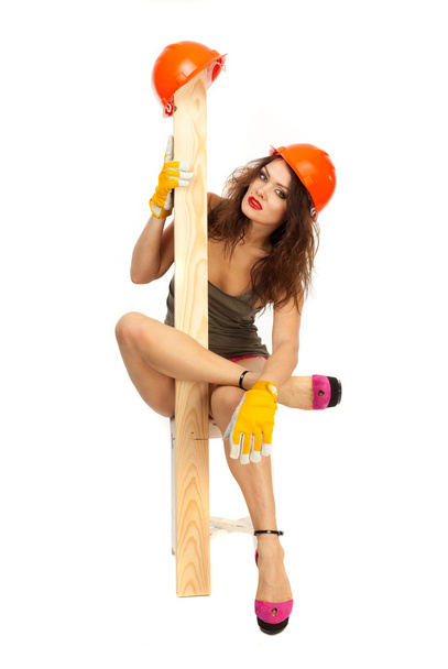 Half-naked beautiful girl in pink panties and orange hard hat on a white background. - Fotografie, Obrázek