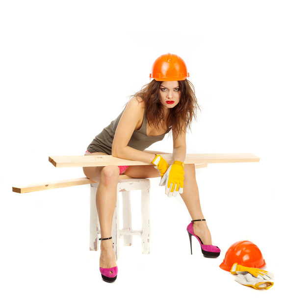 Beautiful girl in pink panties and orange hard hat on a white background. - Fotografie, Obrázek