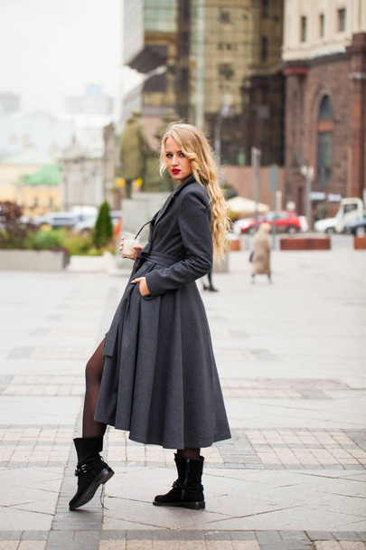 Portrait of a young beautiful woman in gray coat  - 写真・画像