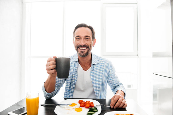 Satisfied mature man drinking coffee - Фото, зображення