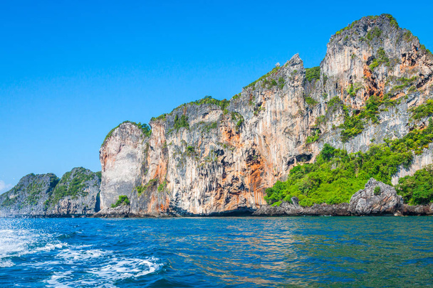 Cliff and the clear sea with a boat near Phi Phi island in south - Photo, image