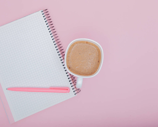 top view business background workspace with coffee, pen and blank notebook on pink background. image for education, desktop, copy space, work, workplace, beverage, mock up concept - Фото, зображення