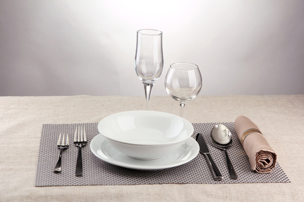 Table setting, on grey background - Φωτογραφία, εικόνα