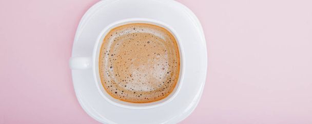 white mug with coffee on a pink background, copy space - Photo, image
