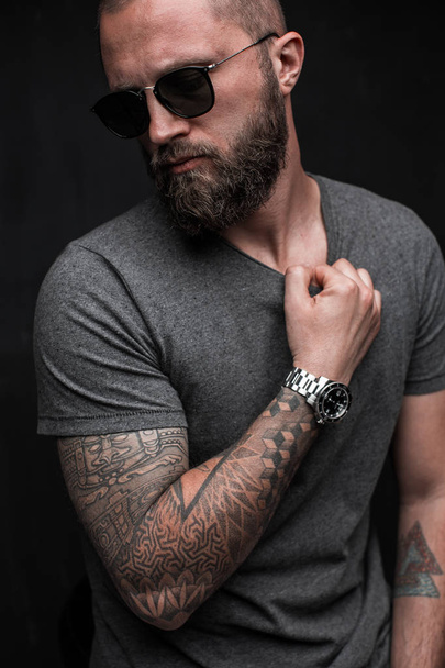 Profile portrait on turned head and long well trimmed beard of handsome man with sunglasses - Photo, Image