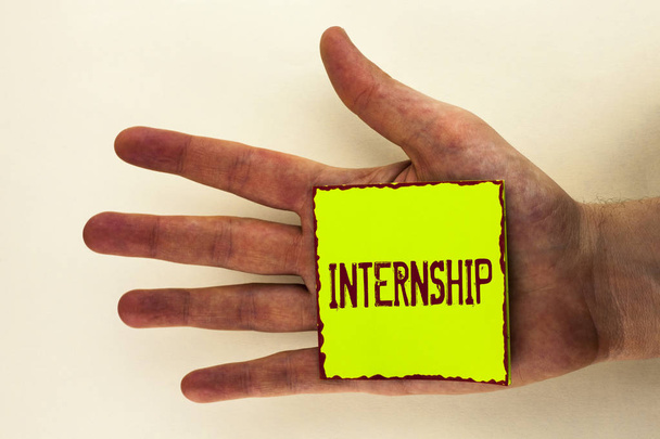 Word writing text Internship. Business concept for Student or trainee who works in a company to obtain experience written on Sticky Note Paper placed on the Hand on the plain background. - Photo, Image