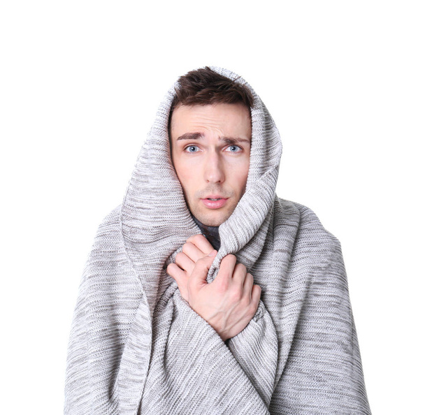 Young man with cold wrapped in blanket on white background - Zdjęcie, obraz