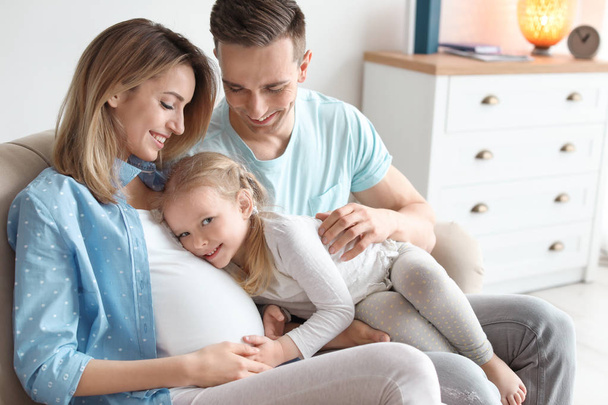 Young pregnant woman with her family at home - Foto, Bild