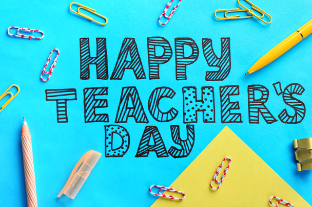 Text HAPPY TEACHER'S DAY and stationery on color paper - Fotografie, Obrázek