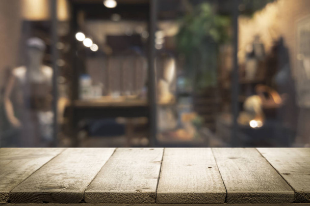 Wooden table with blur background of coffee shop. - Photo, Image