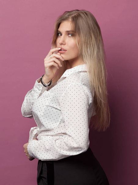 Portrait of a young beautiful caucasian woman on pink background - Fotó, kép