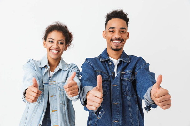Happy african couple in denim shirts showing thumbs up - Photo, Image
