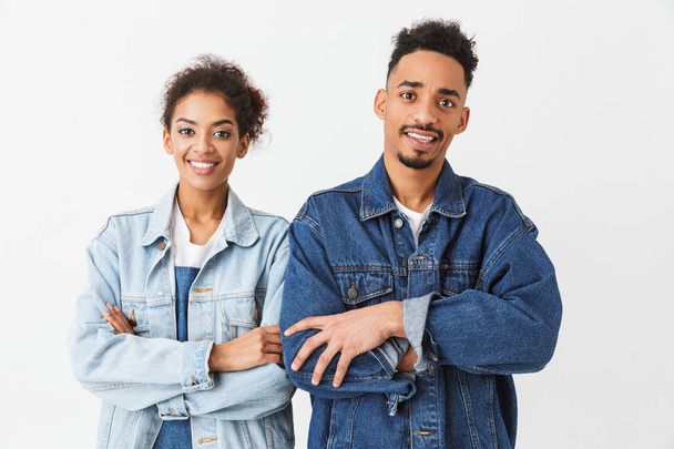 Joyful african couple in denim shirts posing with crossed arms - Foto, afbeelding