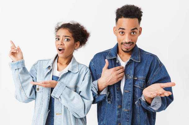 Surprised confused african couple in denim shirts looking at camera - Foto, Bild