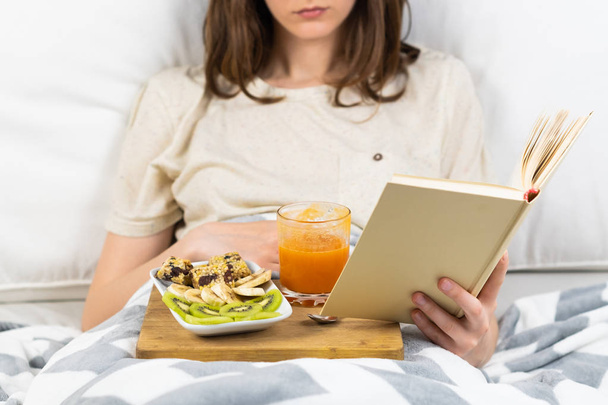 Reading book in bed and having breakfast - Fotó, kép