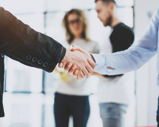 Close up view of business partnership handshake.Concept two coworkers handshaking process.Successful deal after great meeting.Blurred background. - Foto, Imagem