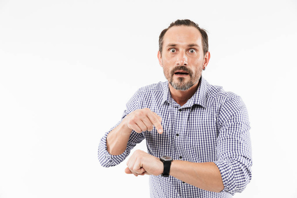Shocked adult man pointing at watch. - Foto, imagen