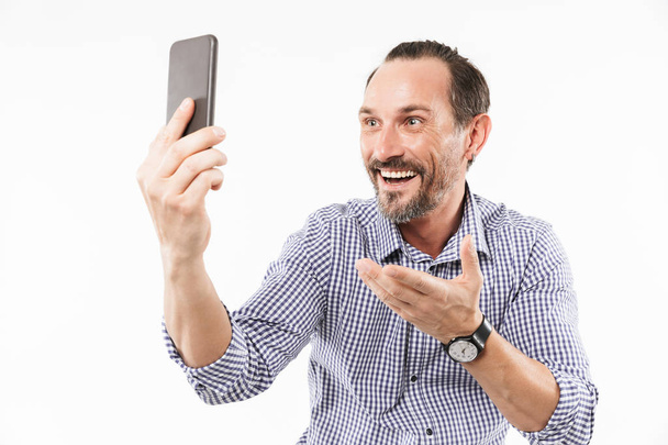 Laughing adult man talking by mobile phone. - Foto, afbeelding