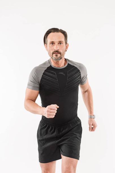 Portrait of focused motivated adult man 30s wearing sportswear h - Photo, image