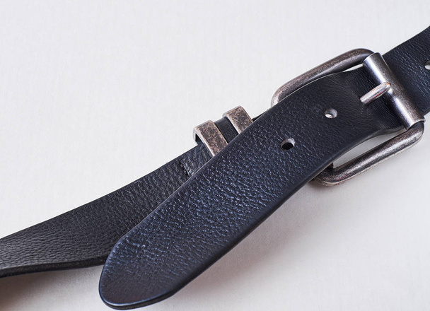 Men`s jeans belt is an element both practical and decorative. With the classic black belt, you can create a win-win stylish bow. - Photo, image