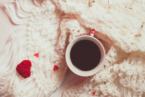 Cup of coffee with warm knitted scarf - Photo, Image